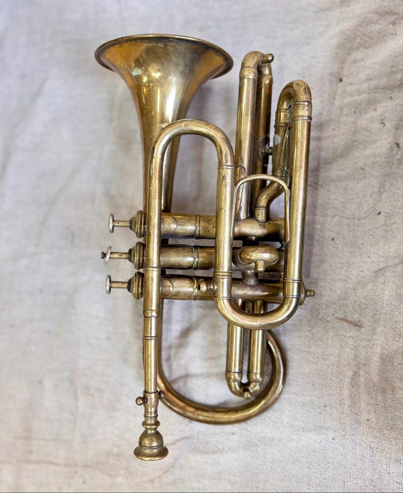 Brass corent on a textured beige background