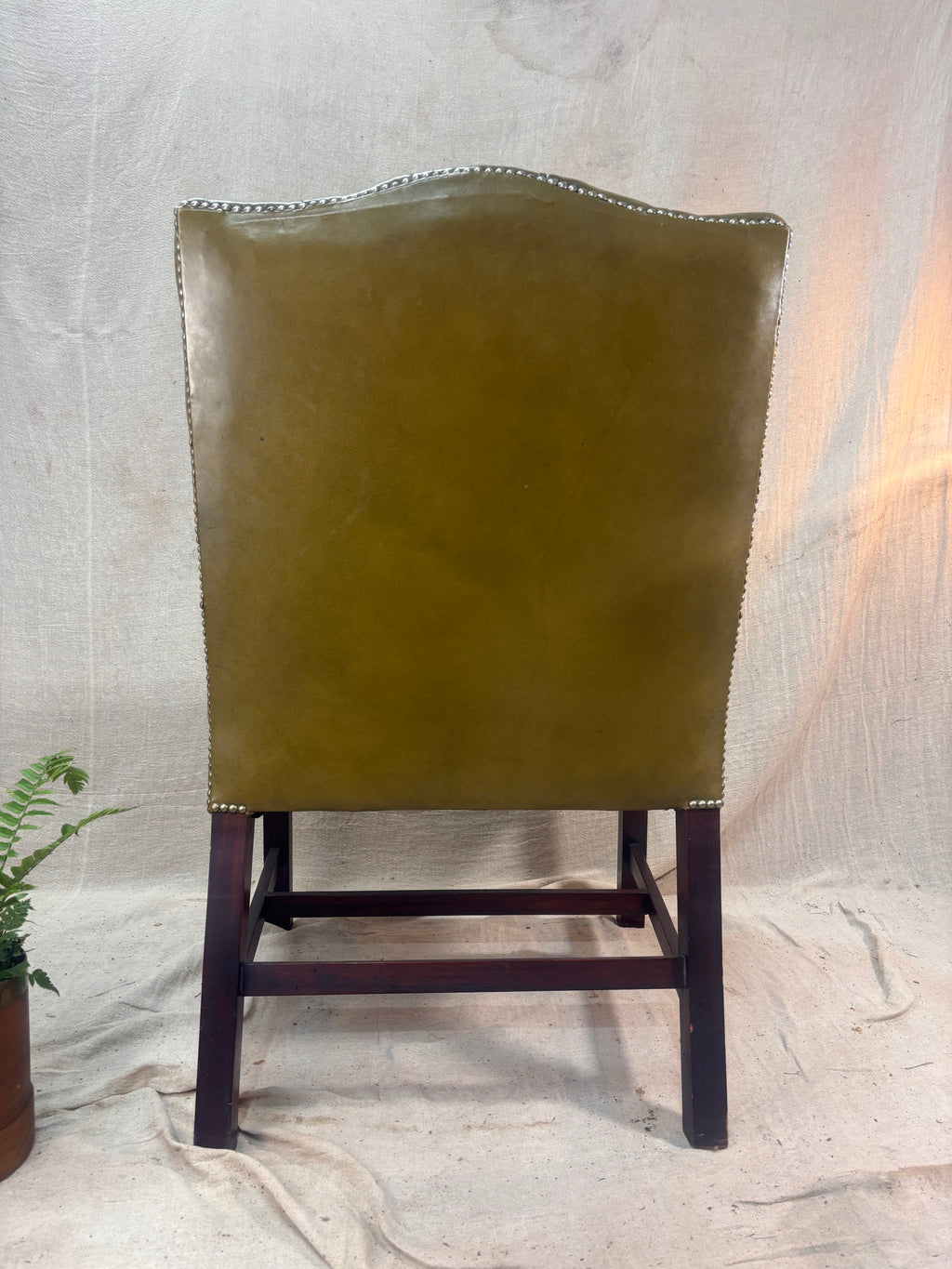 A Green Button Back Armchair