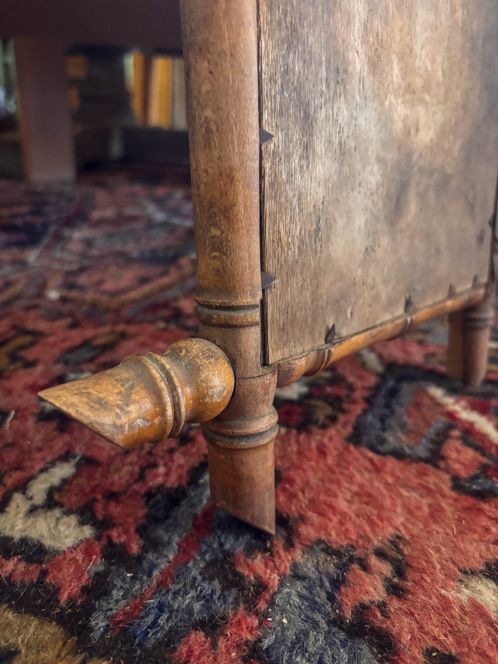 Close-up of a corner of a bamboo mirror with a patterned rug in the background