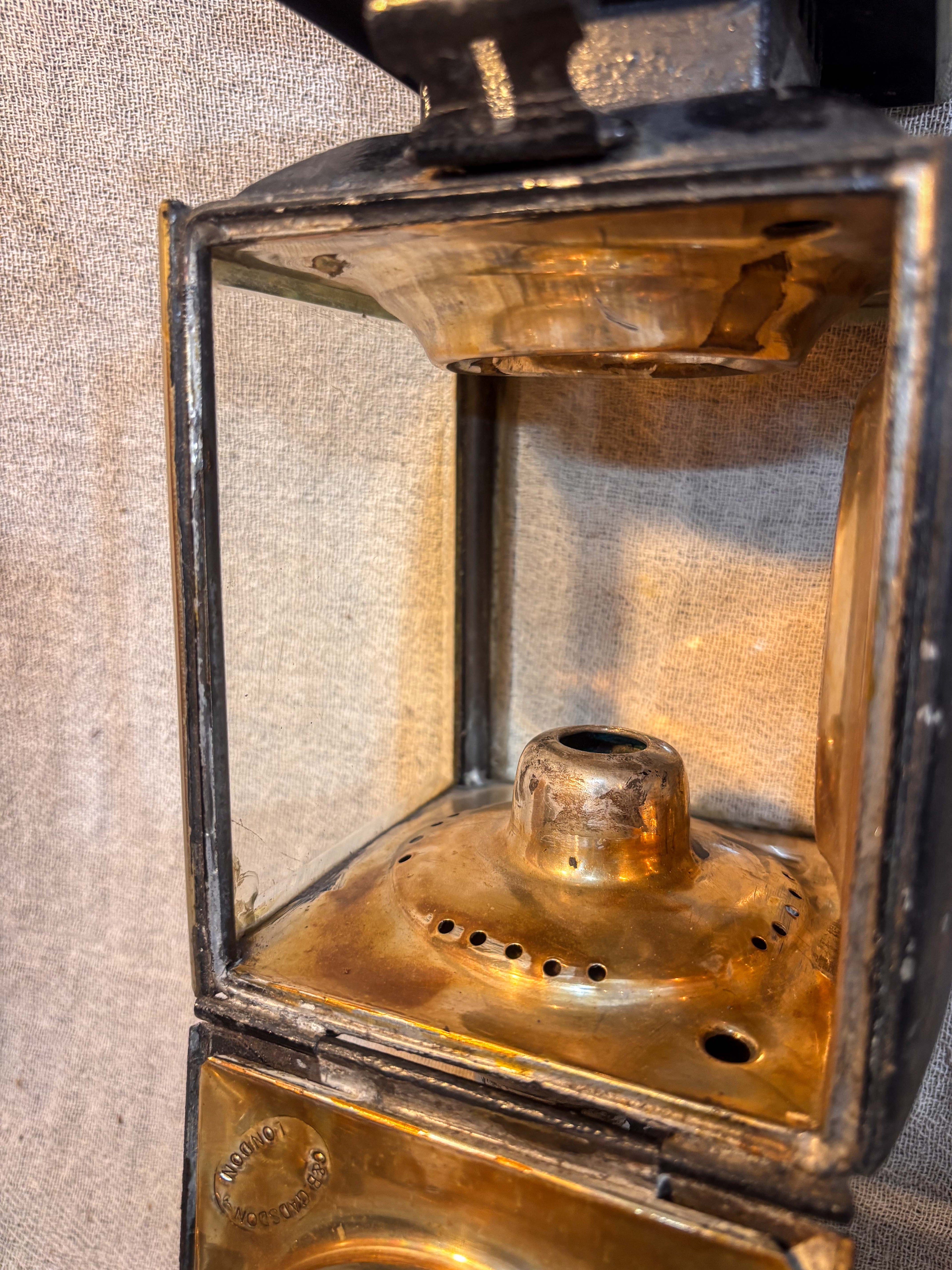 Close-up of a antique candle lamp with brass components on a textured background