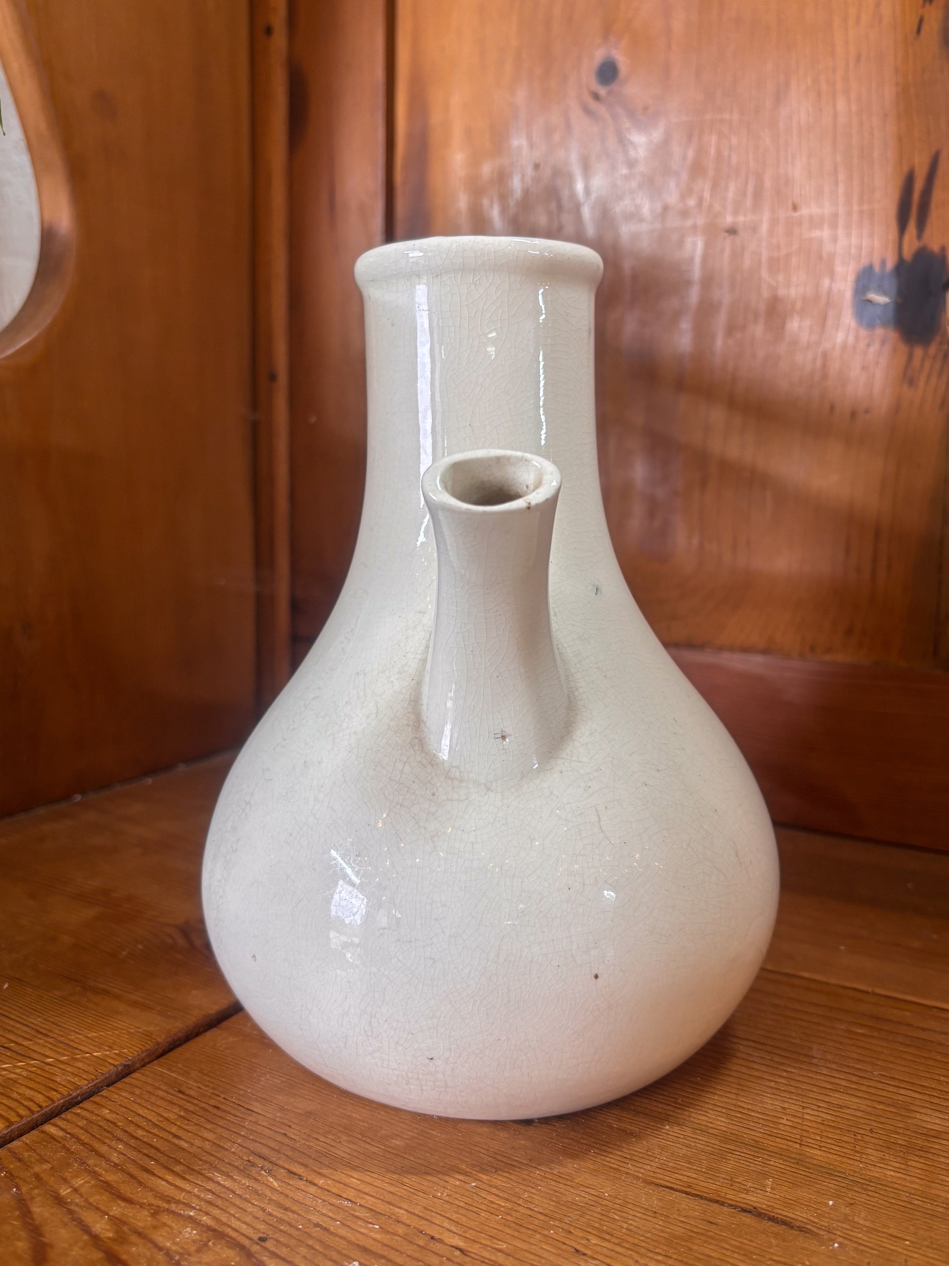 White ceramic inhaler on a wooden surface with a wooden background