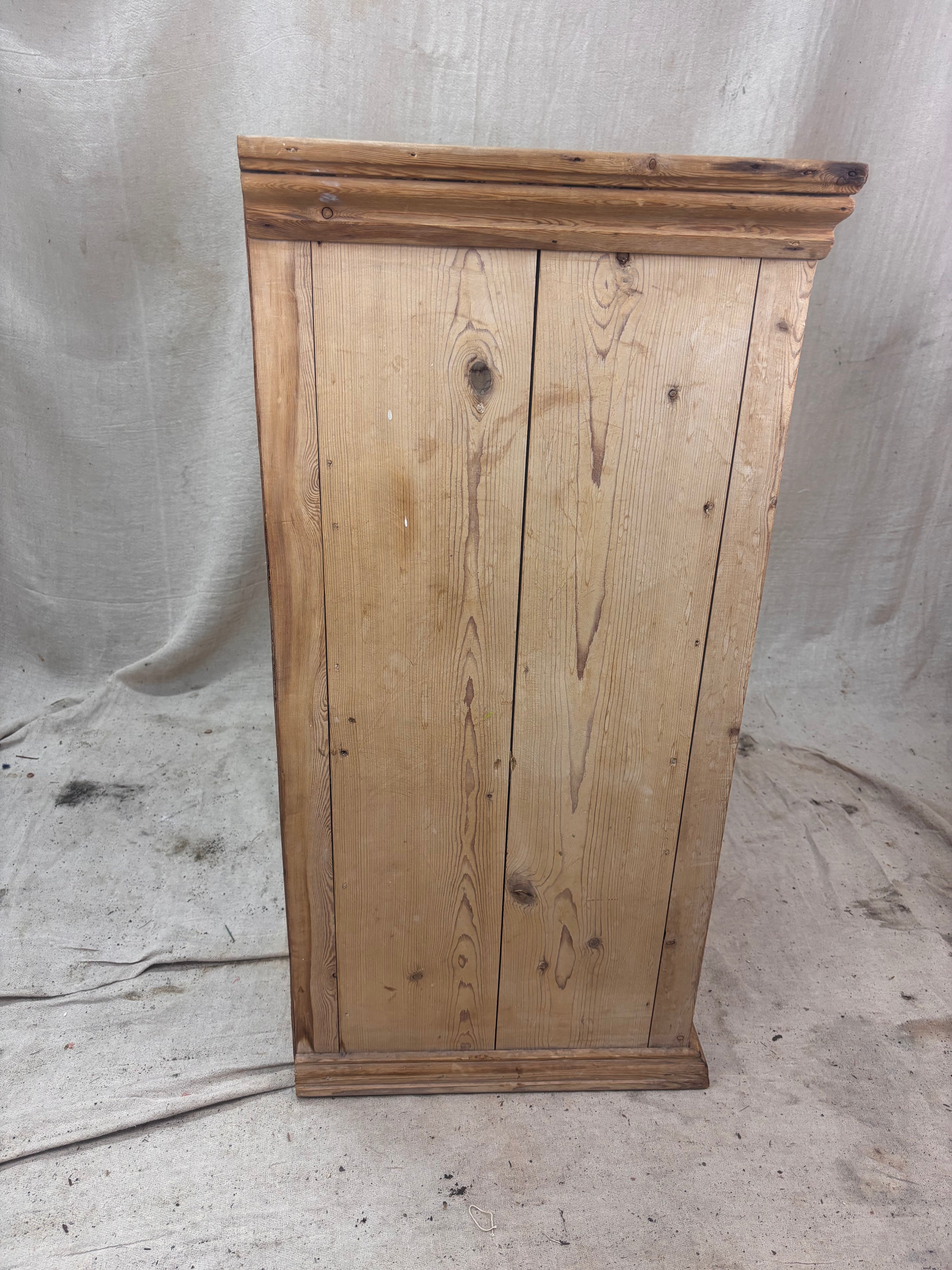 Wooden cabinet with a rustic finish on a plain background