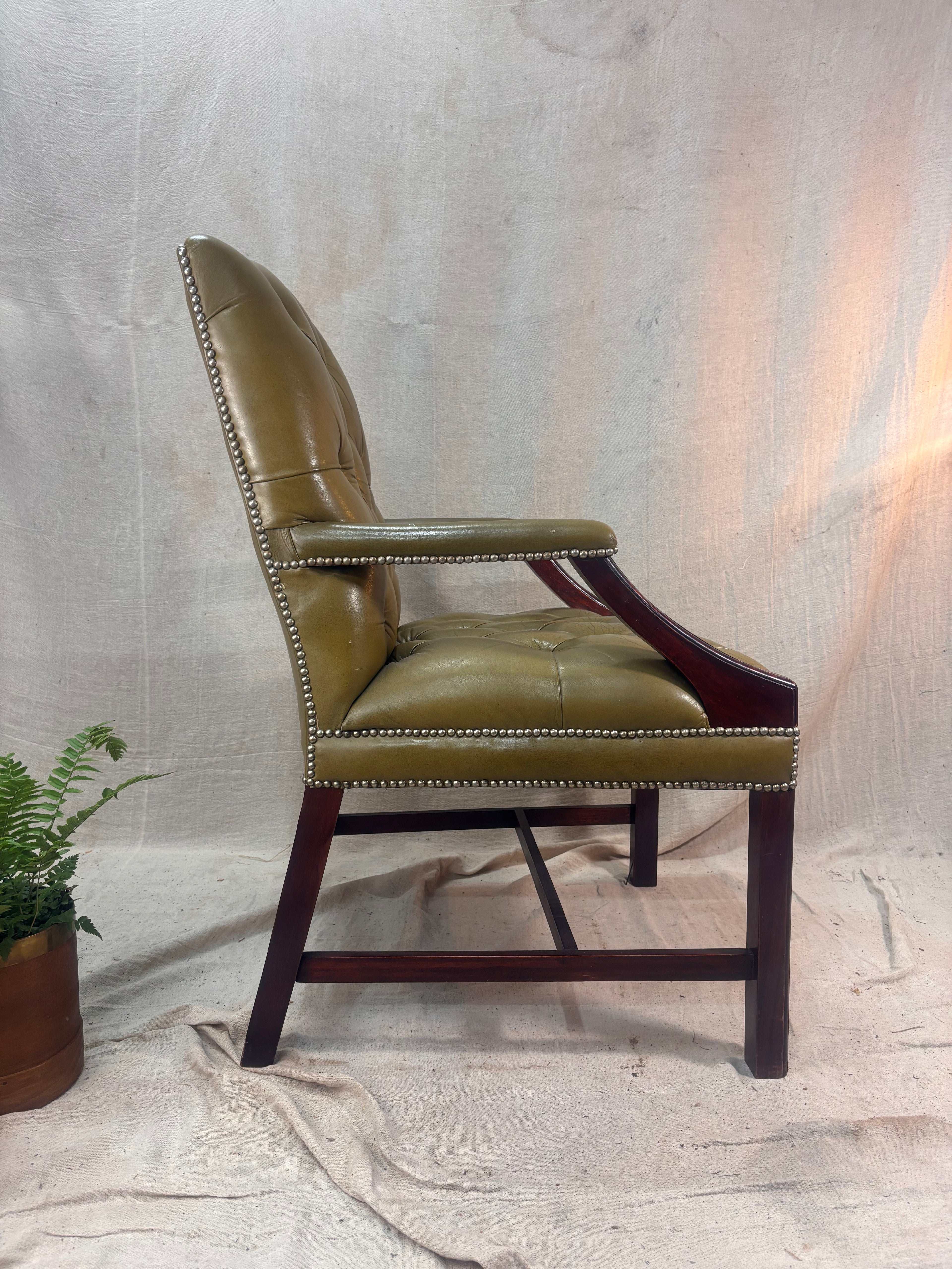 A Green Button Back Armchair