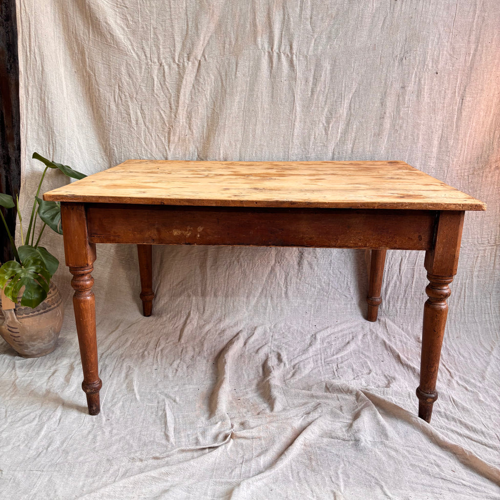 Wooden table on a textured white fabric background