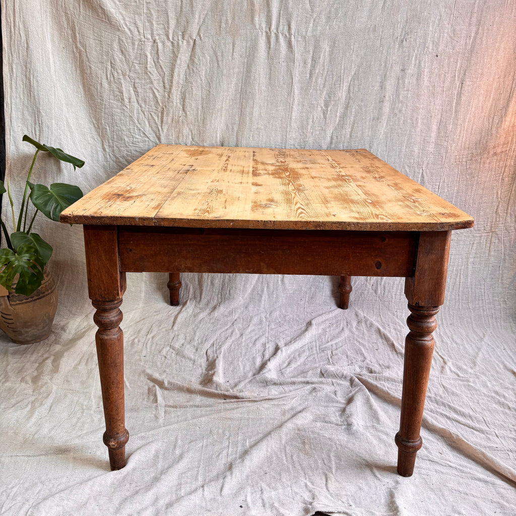 Wooden table with a checkered surface on a white fabric background