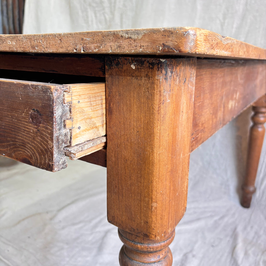 Close-up of a wooden table with a visible drawer on a white background