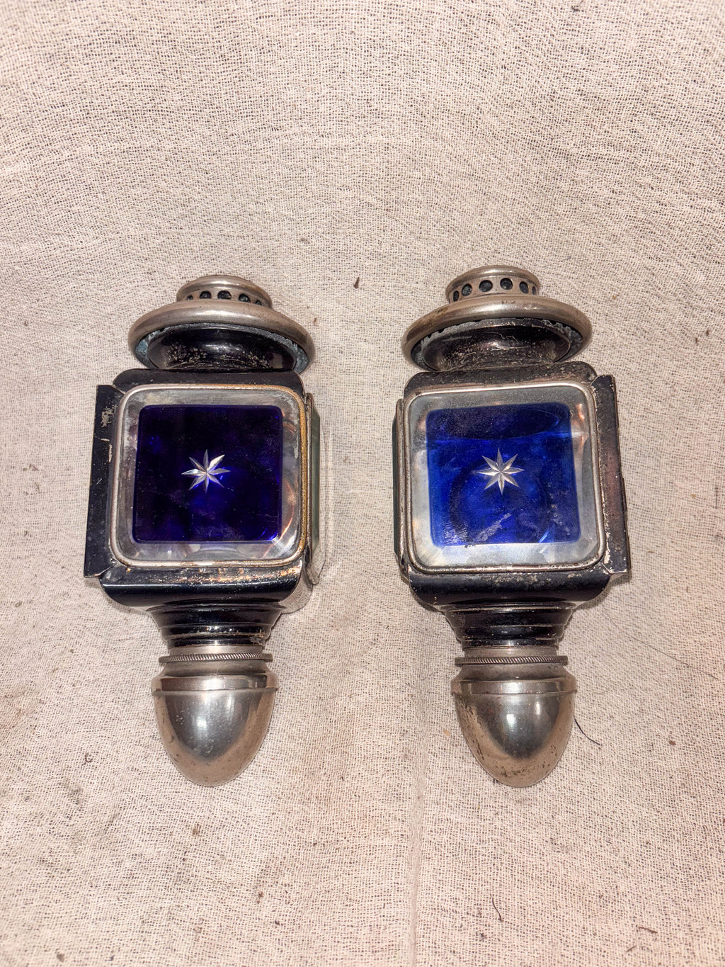 Blue Glass Carriage Lamps on a cloth background