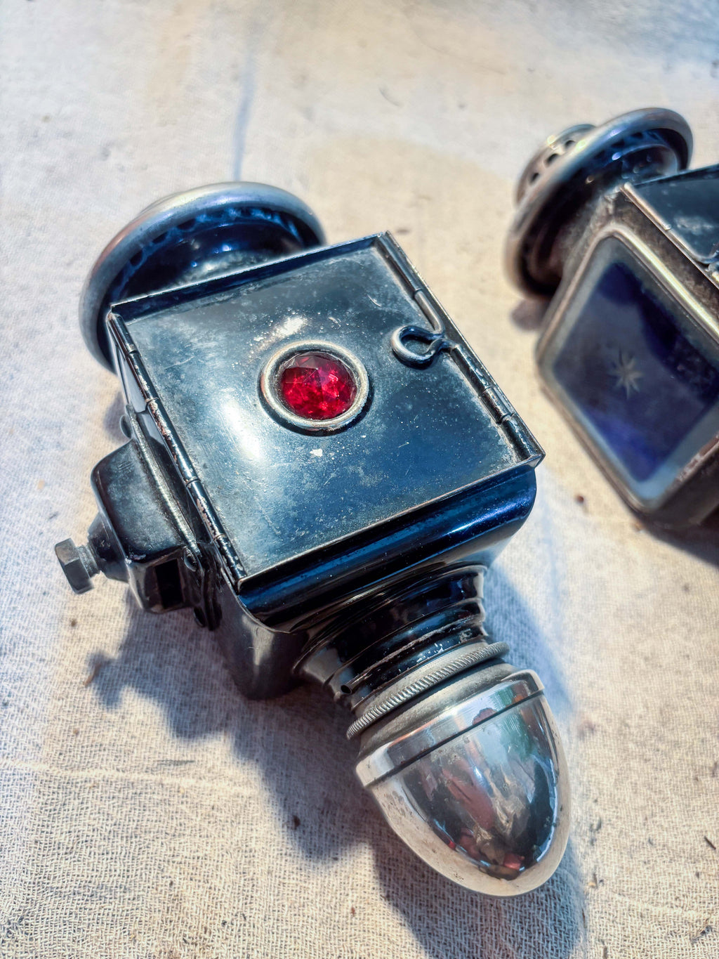 carraige lamp with red glass on cream background