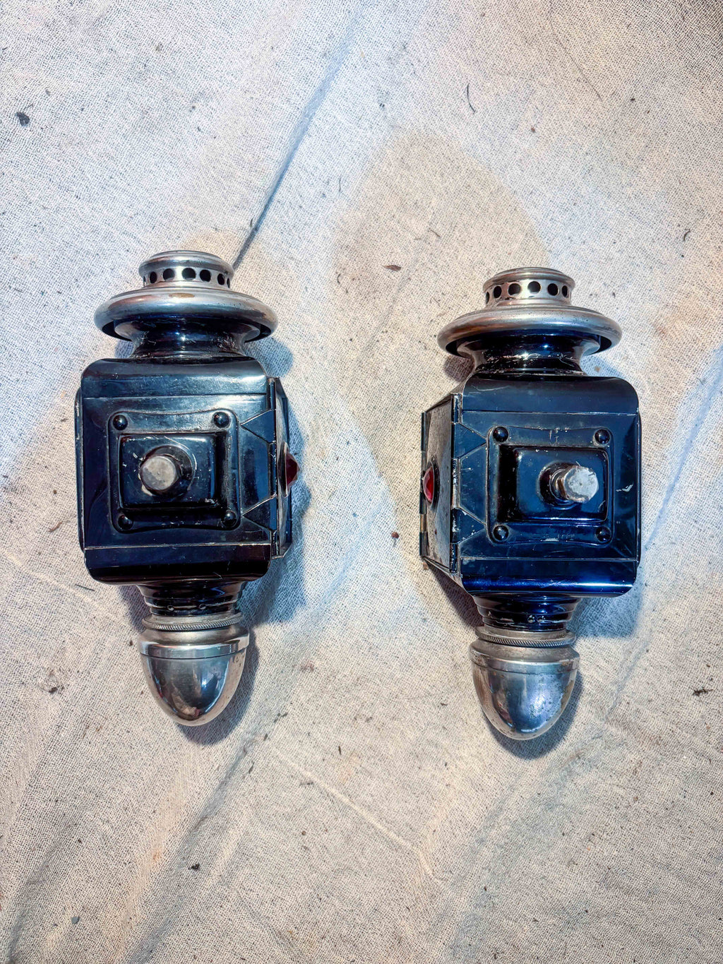 Pair of carriage lamps on a cloth background