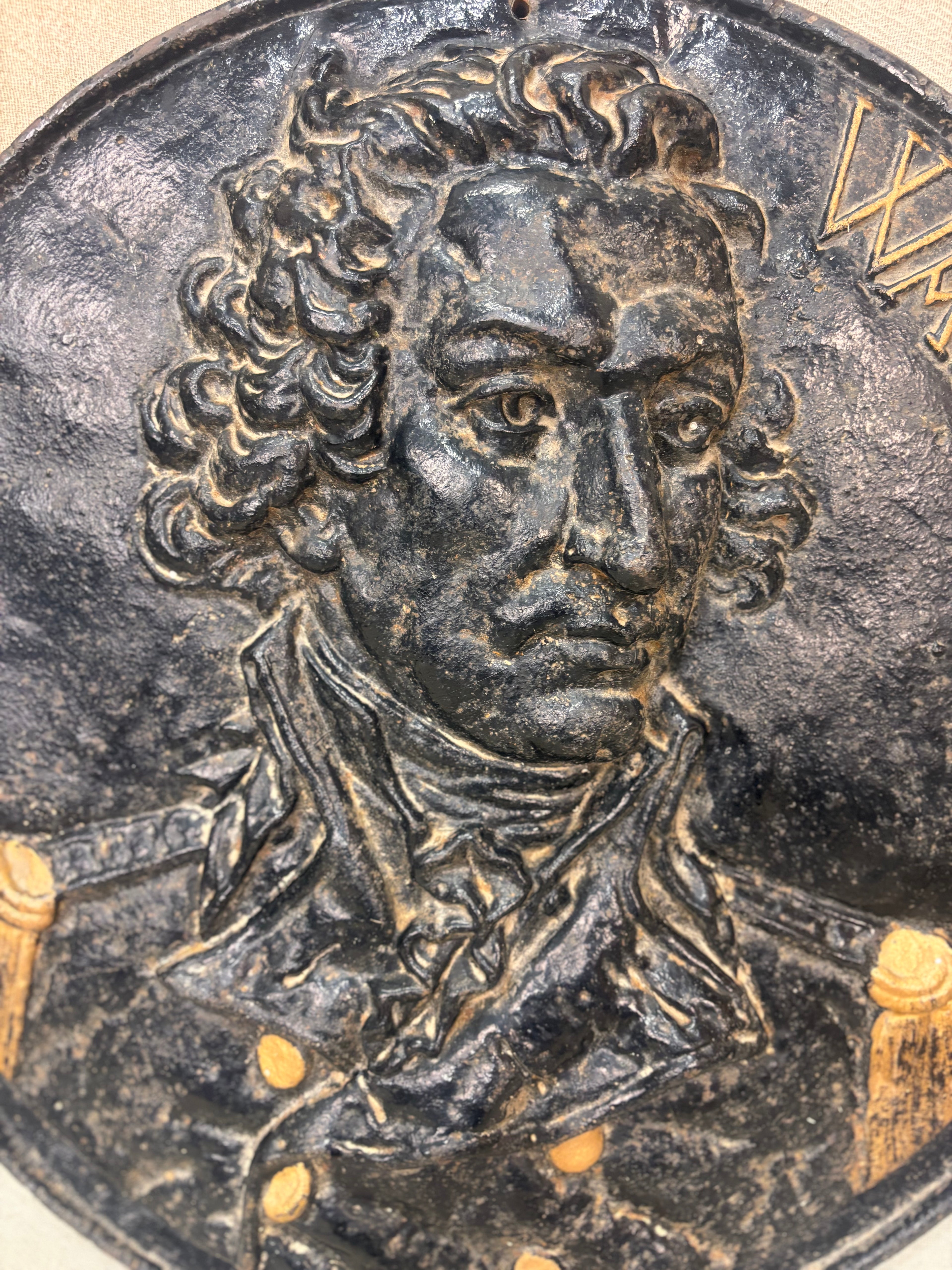 Cast Iron Plaque with a detailed portrait of a person on a dark background