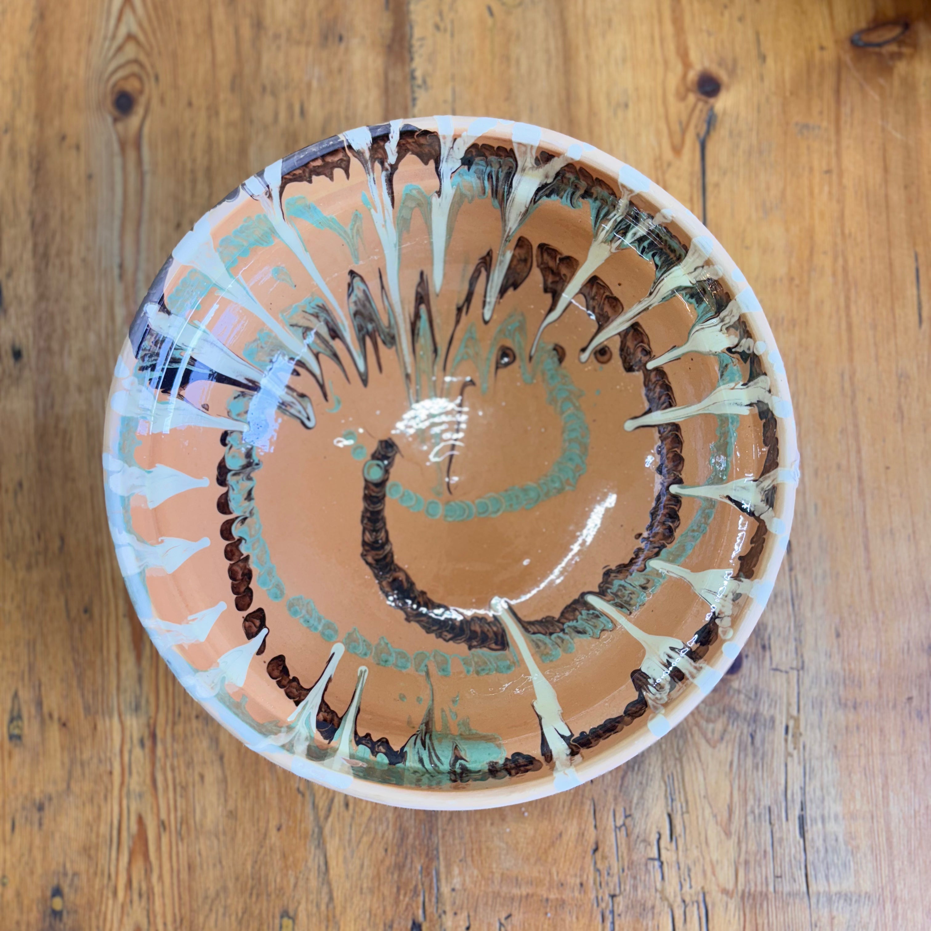 Ceramic bowl with abstract design on a wooden surface