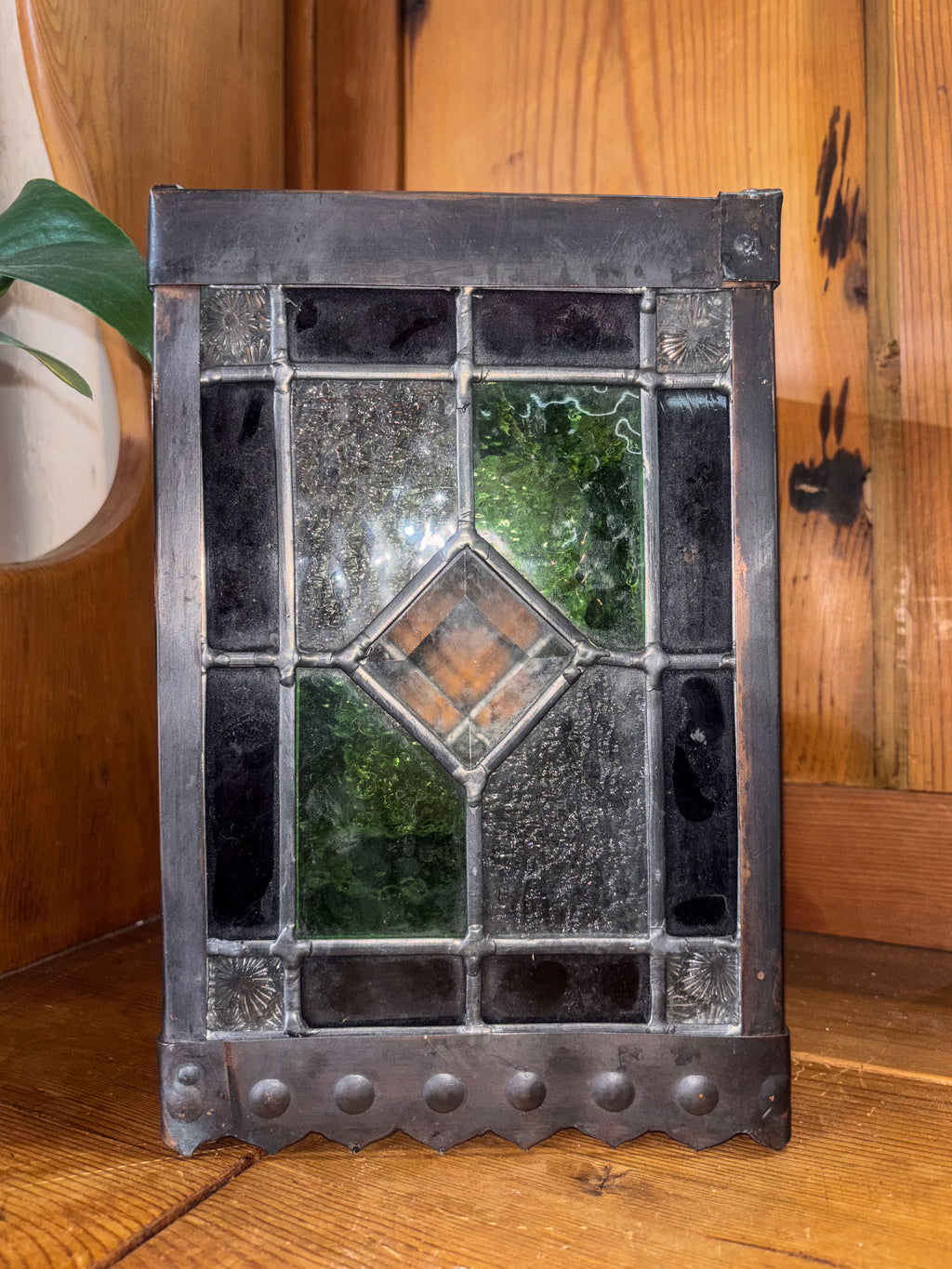Decorative stained glass lantern on a wooden surface