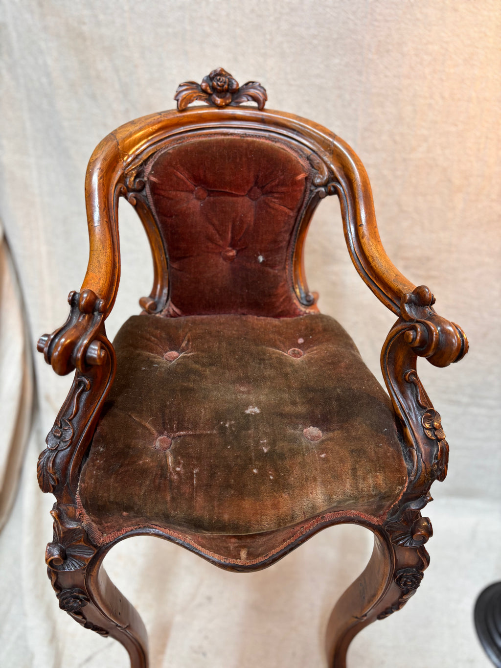 Vintage wooden chair with brown leather seat on a textured white background