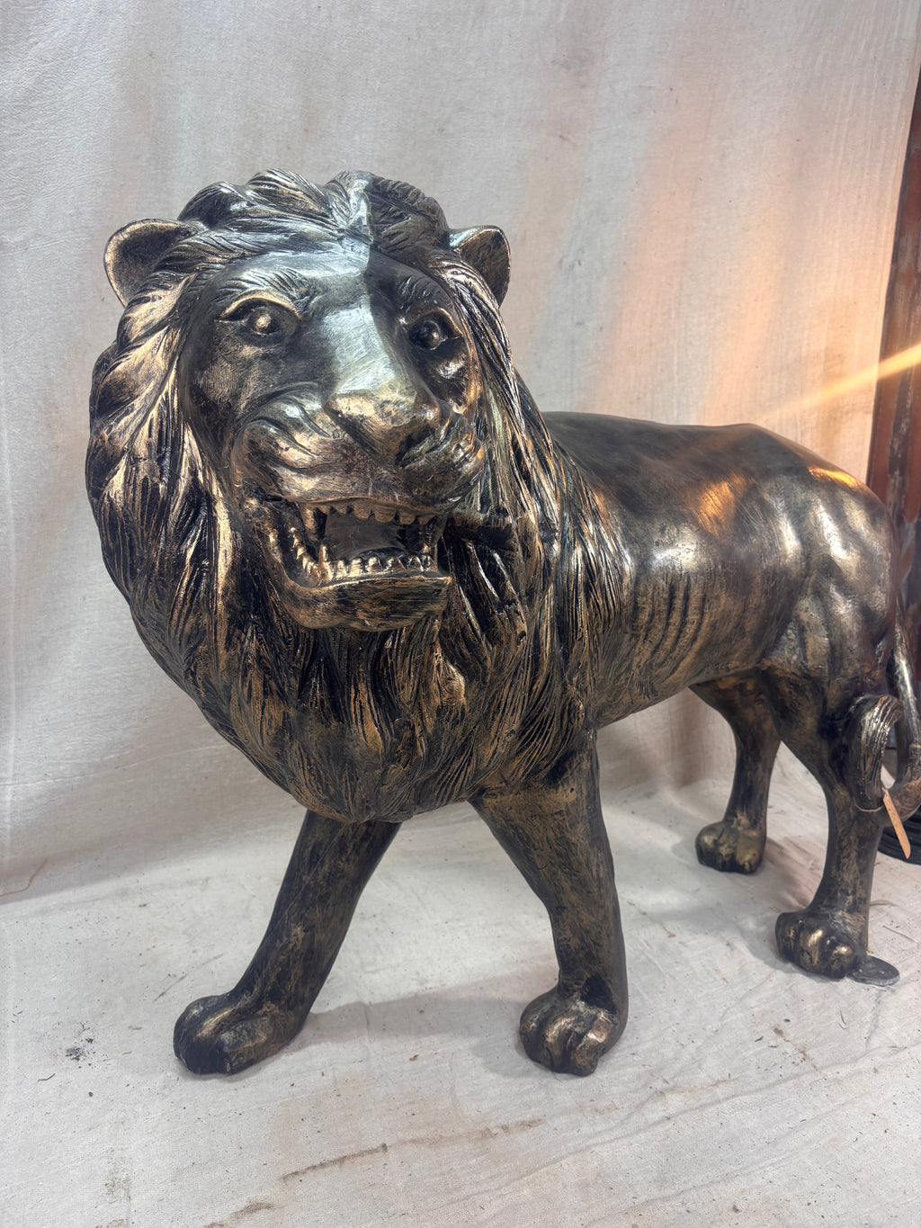 Bronze lion statue on a light background