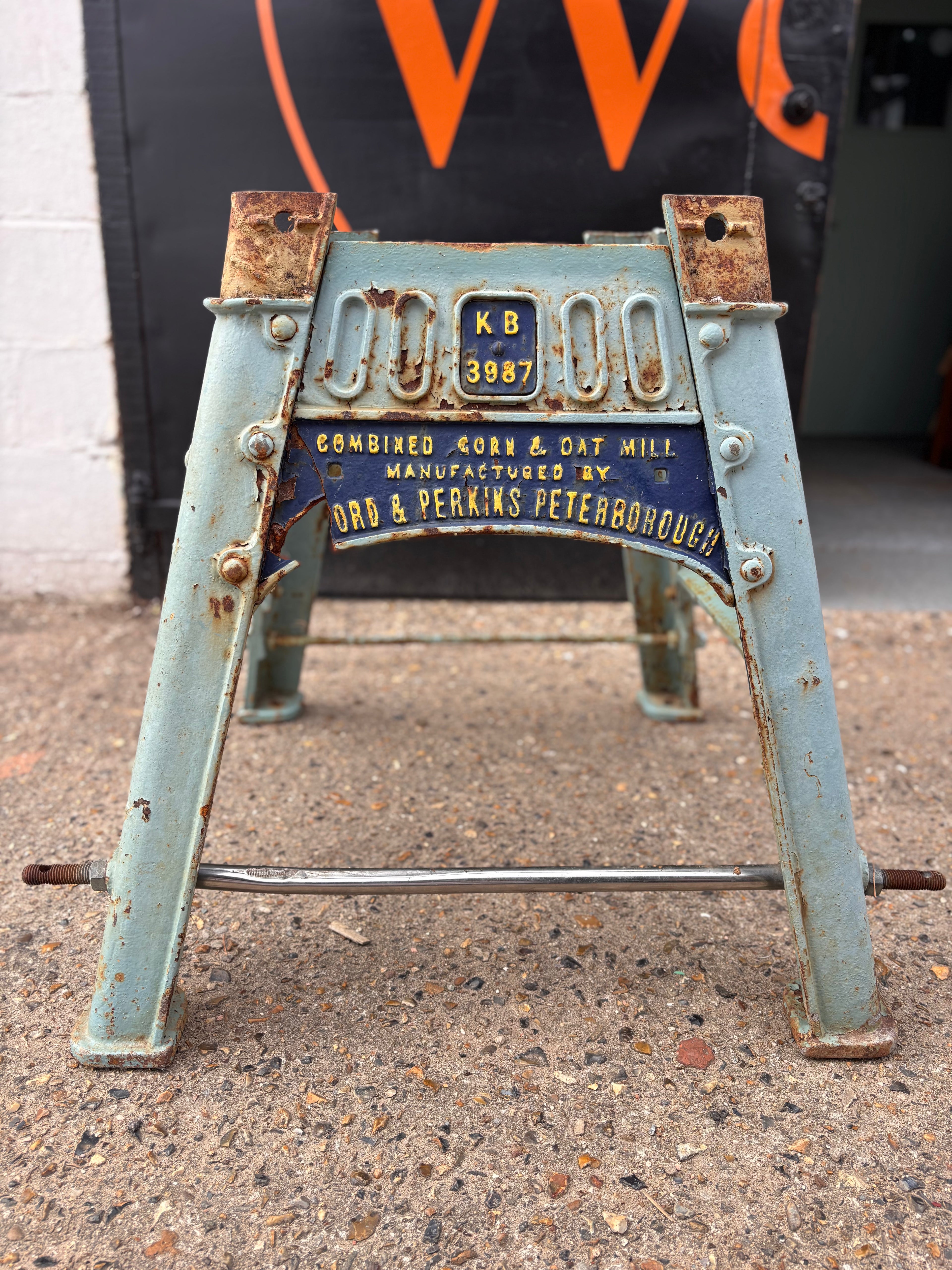 Rustic metal stand with vintage branding on a concrete surface