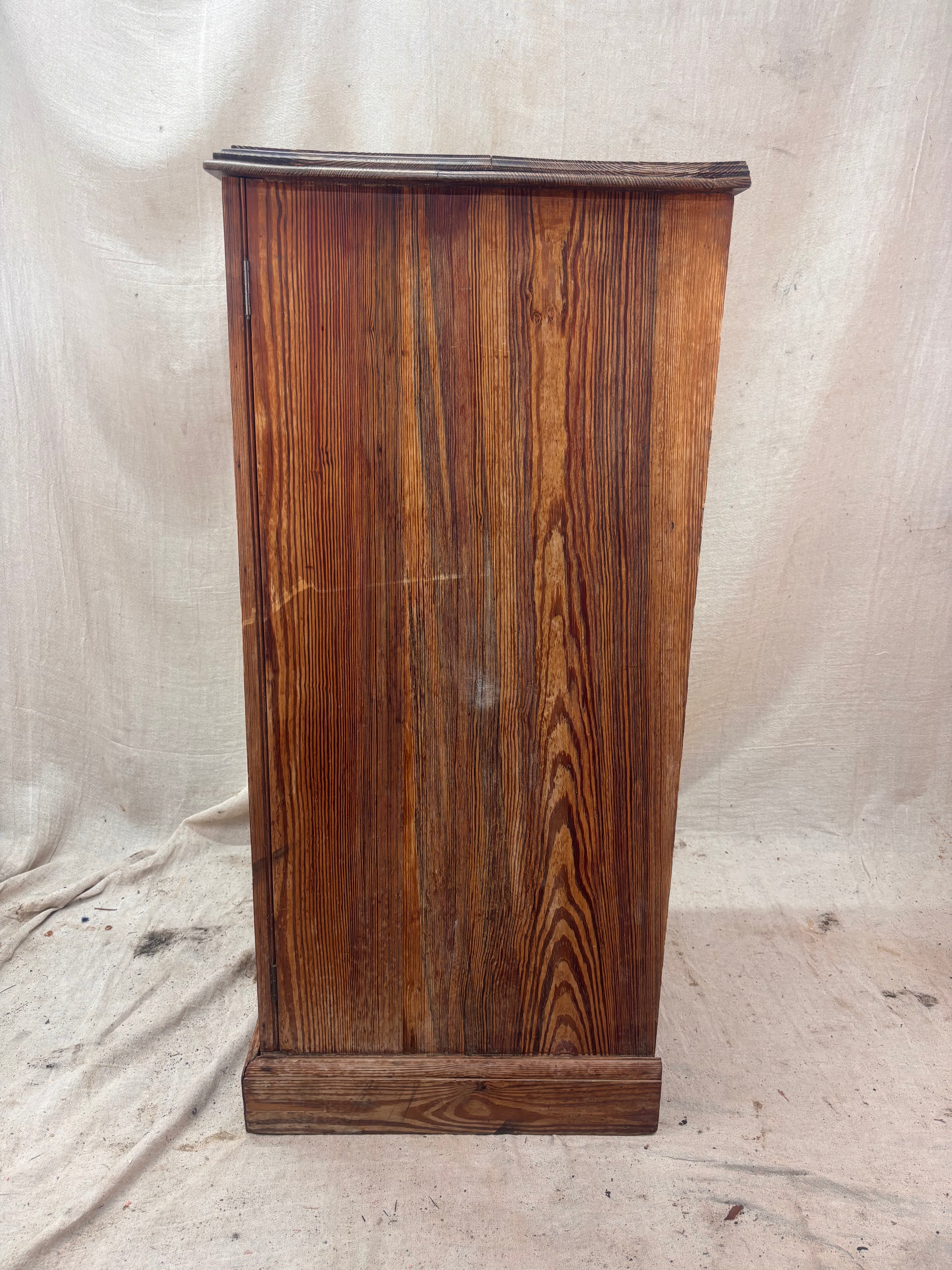 Wooden cabinet with a textured surface on a plain background