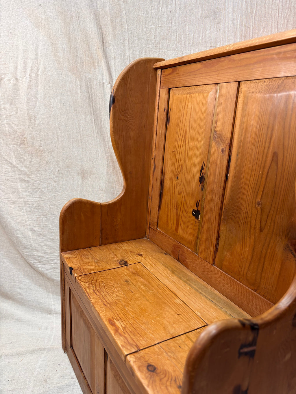 Wooden bench with backrest on a textured white background