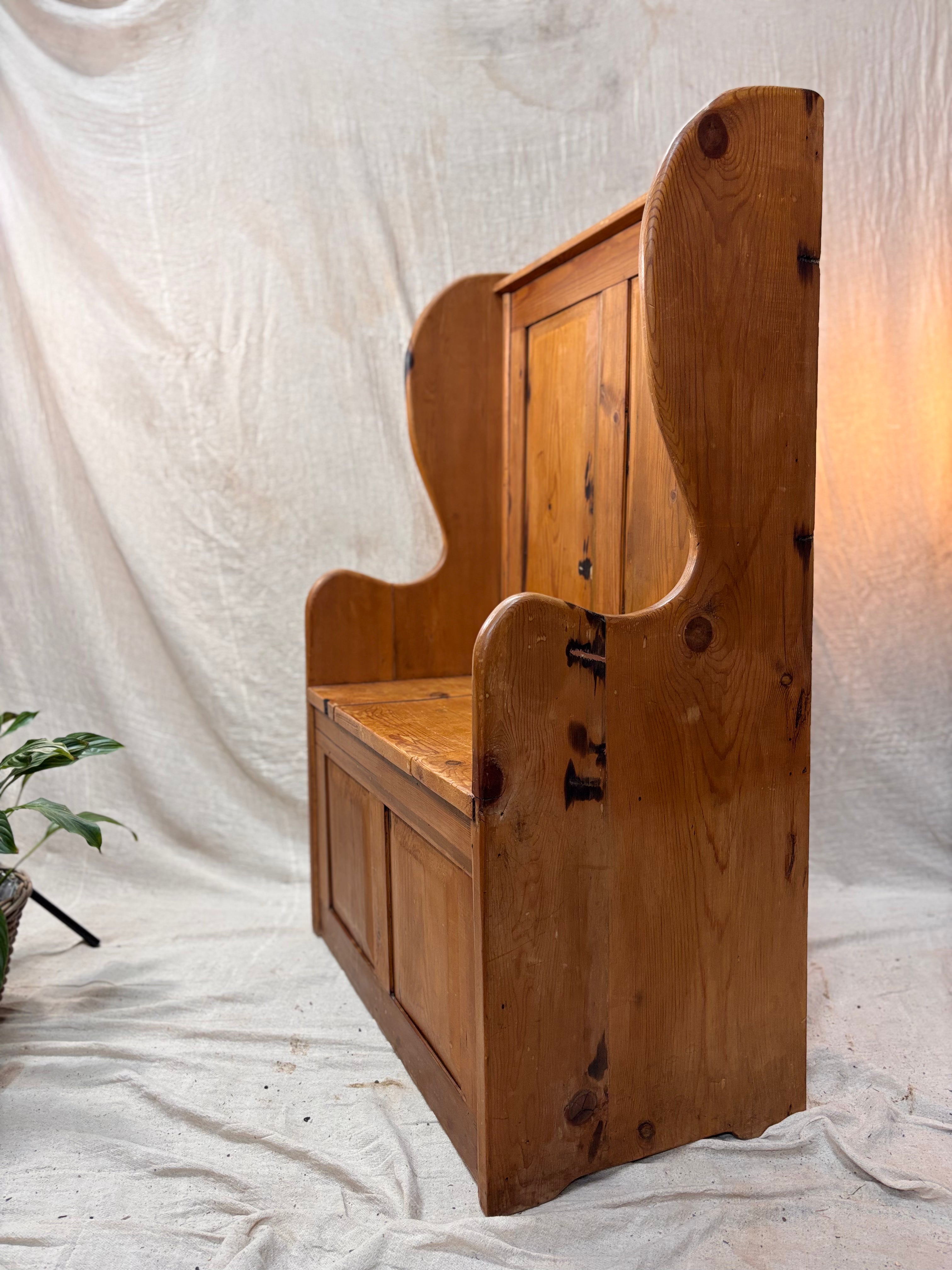 Wooden bench with storage on a plain background