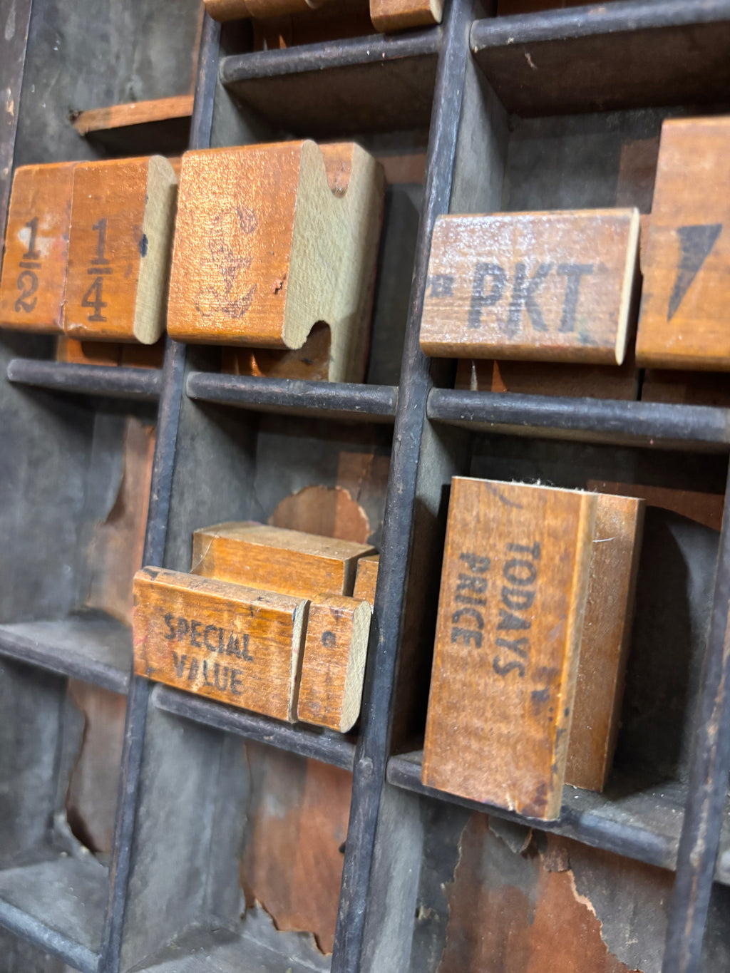 Vintage wooden printing blocks with text on a metal tray