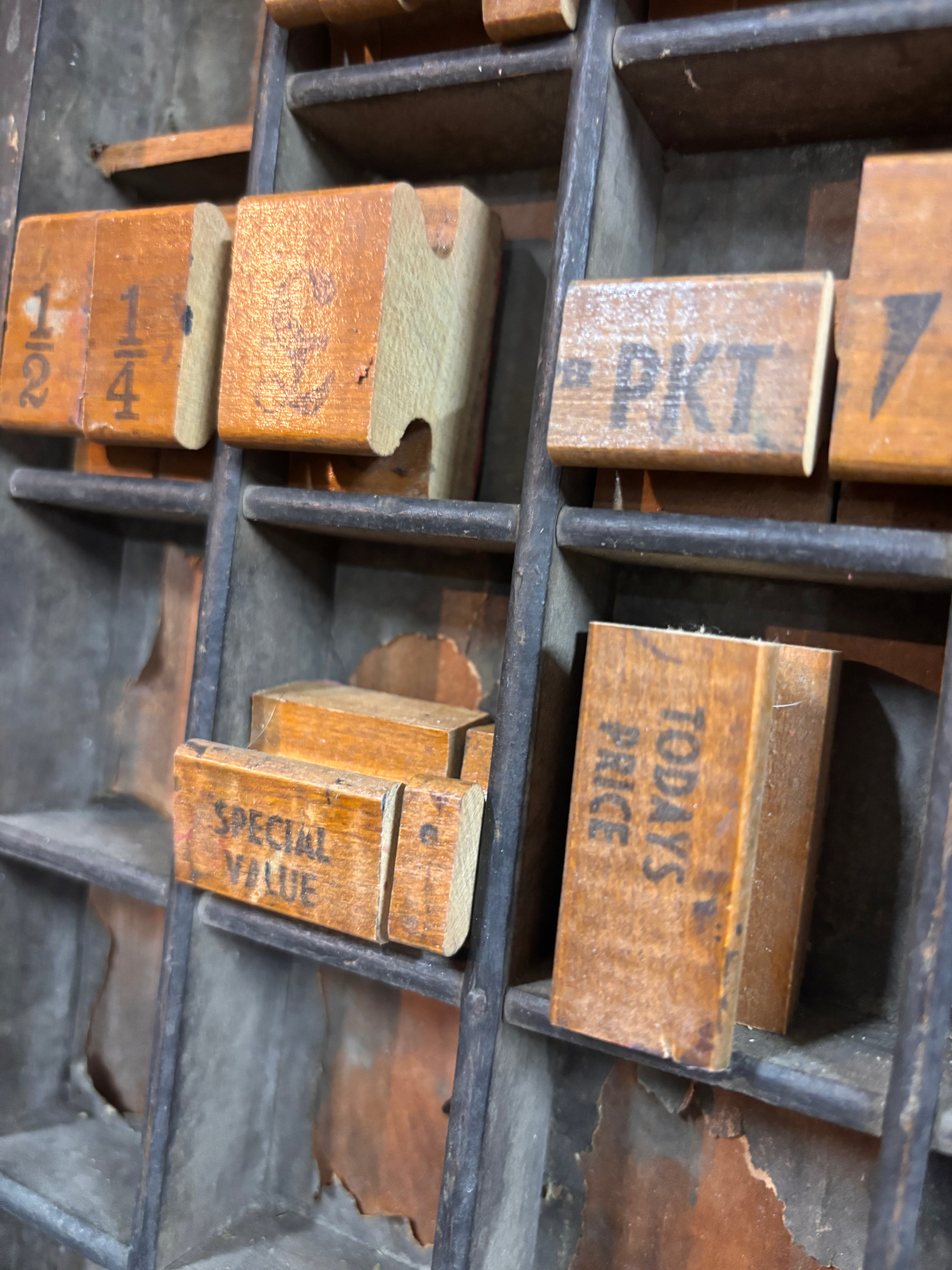 Vintage wooden printing blocks with text on a metal tray