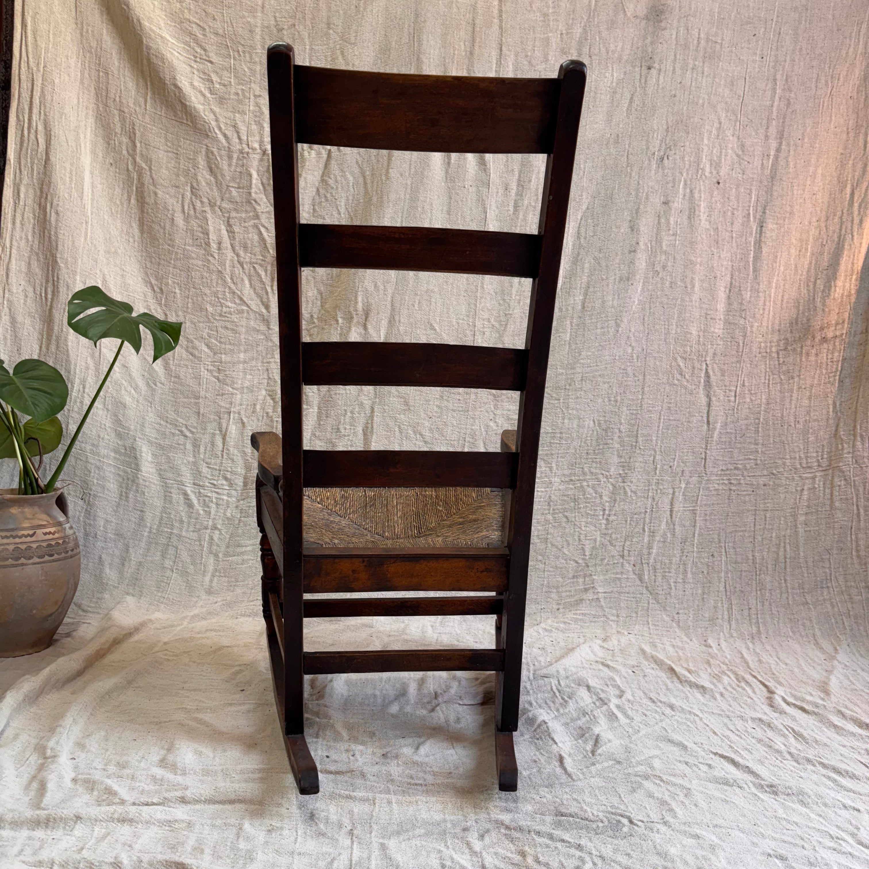 Wooden ladder-back chair on a textured white fabric background