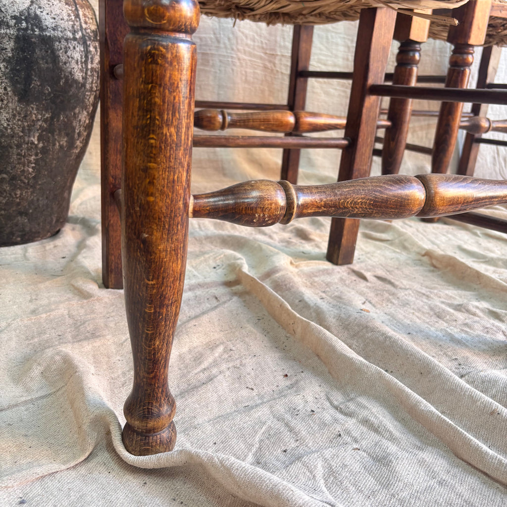 Close-up of a wooden chair leg on a textured surface