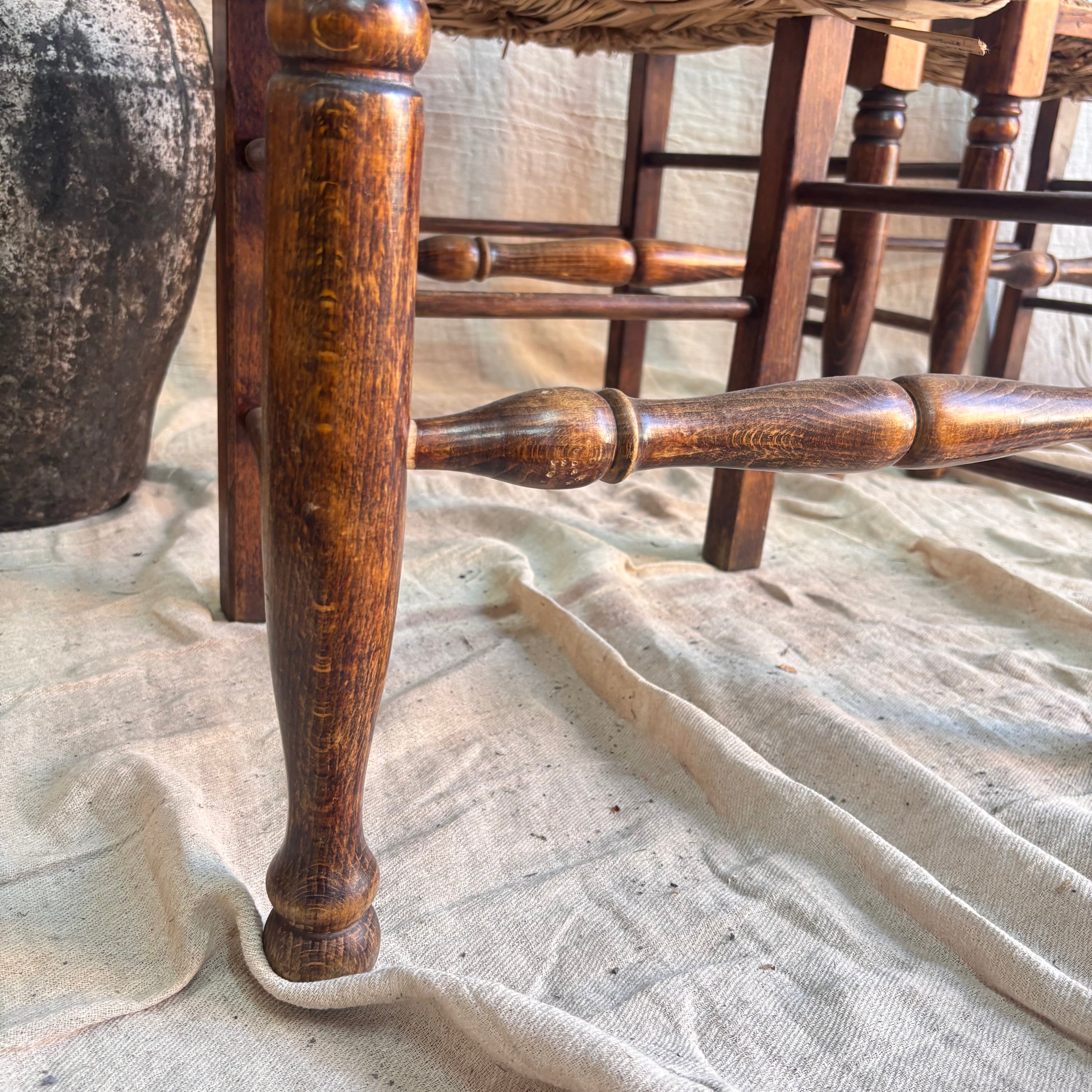 Close-up of a wooden chair leg on a textured surface