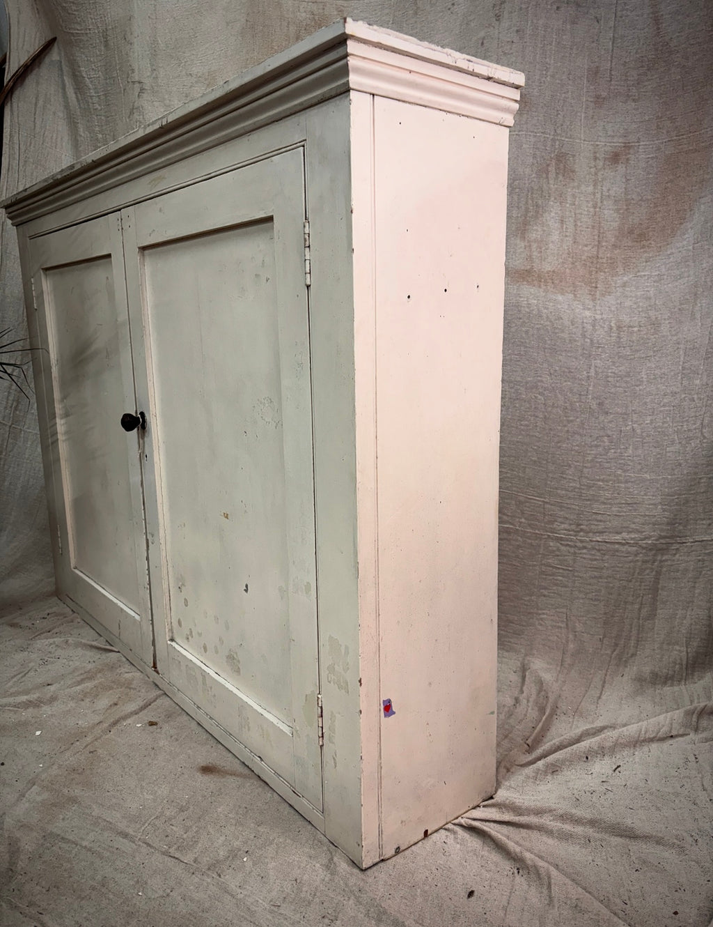 Vintage wooden cabinet with two doors on a plain background