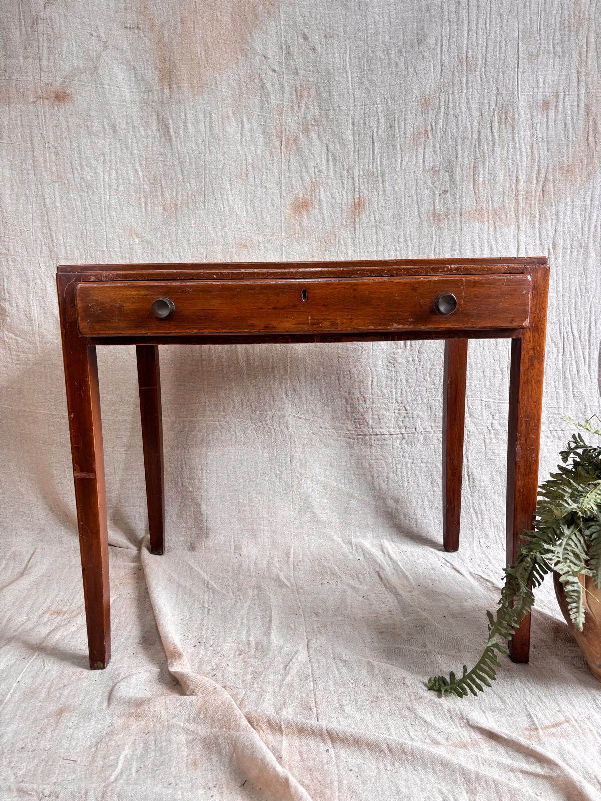 Wooden desk with a single drawer on a textured white background
