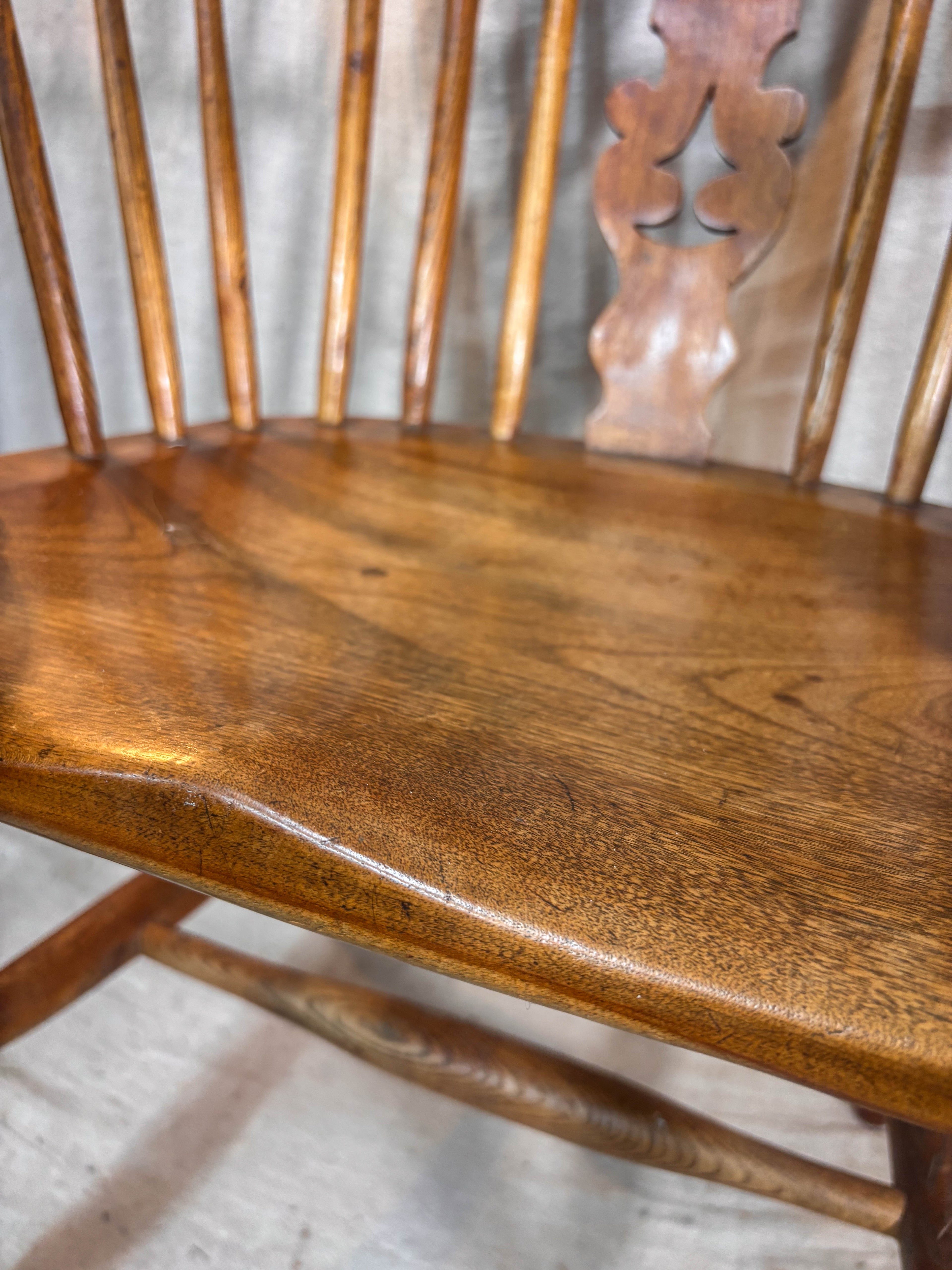 Close-up of a wooden chair seat with a blurred background