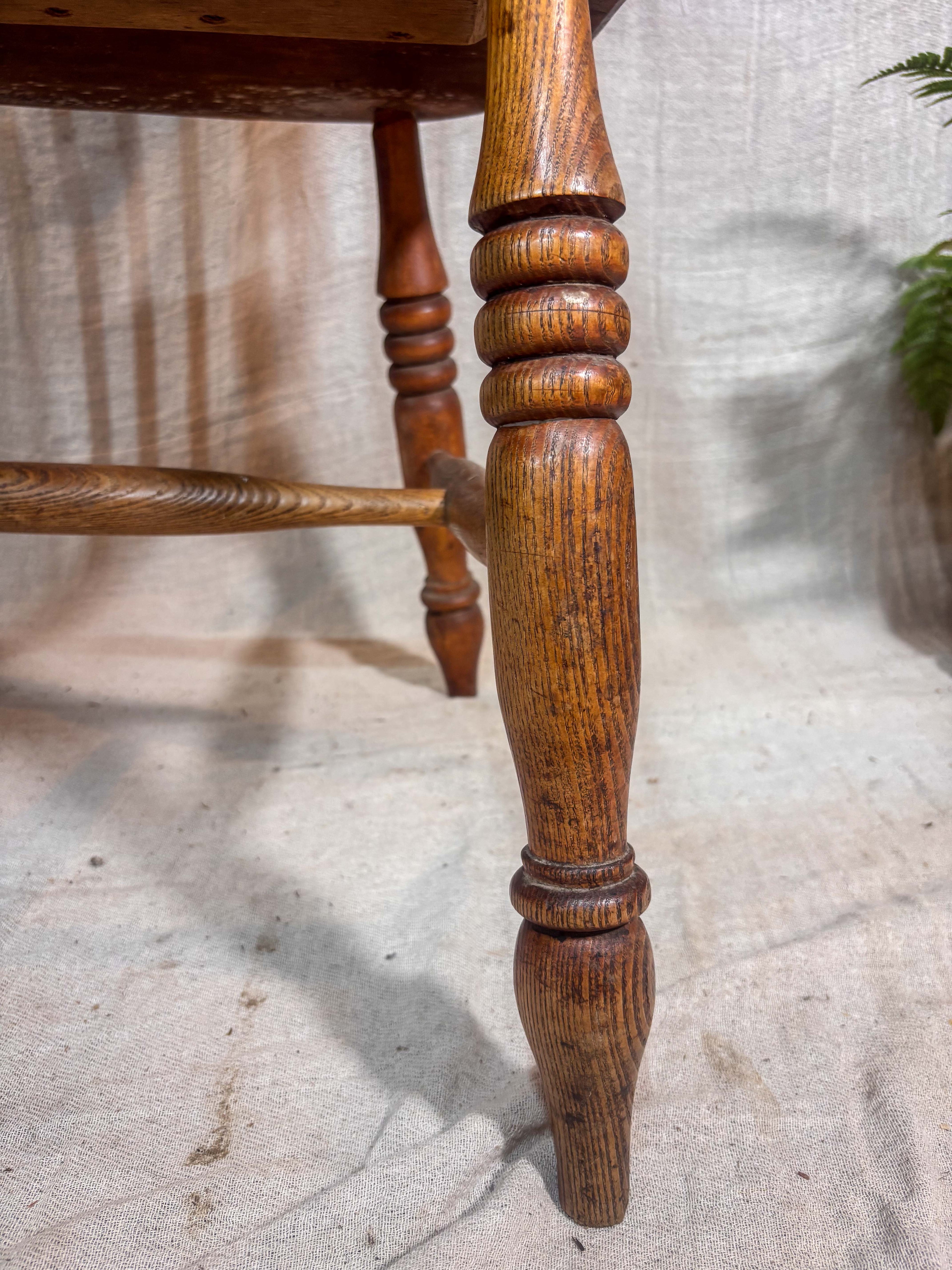 Close-up of a wooden chair leg on a textured floor