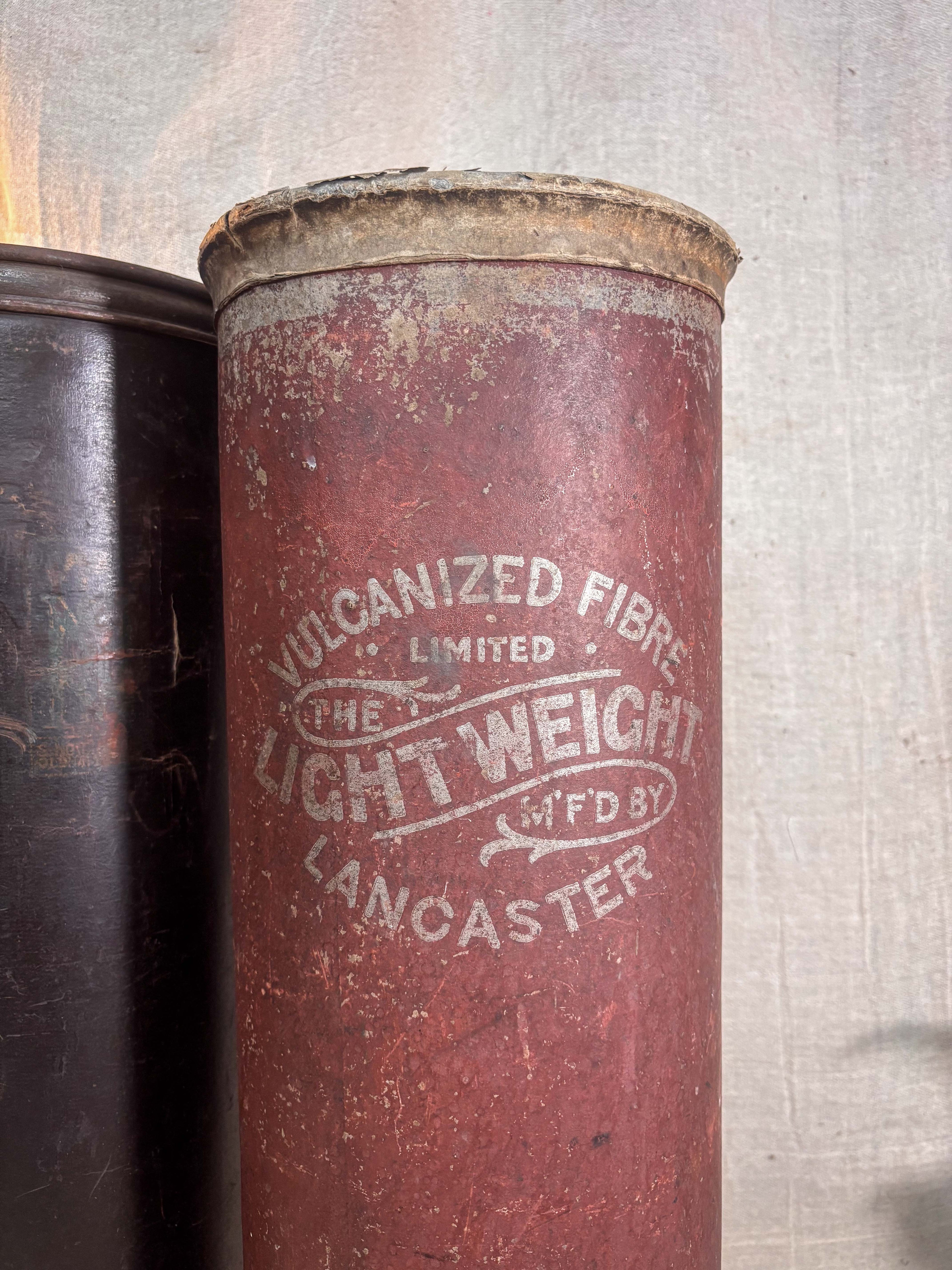 Vintage cylindrical container with 'Vulcanized Fibre Limited' branding on a textured background