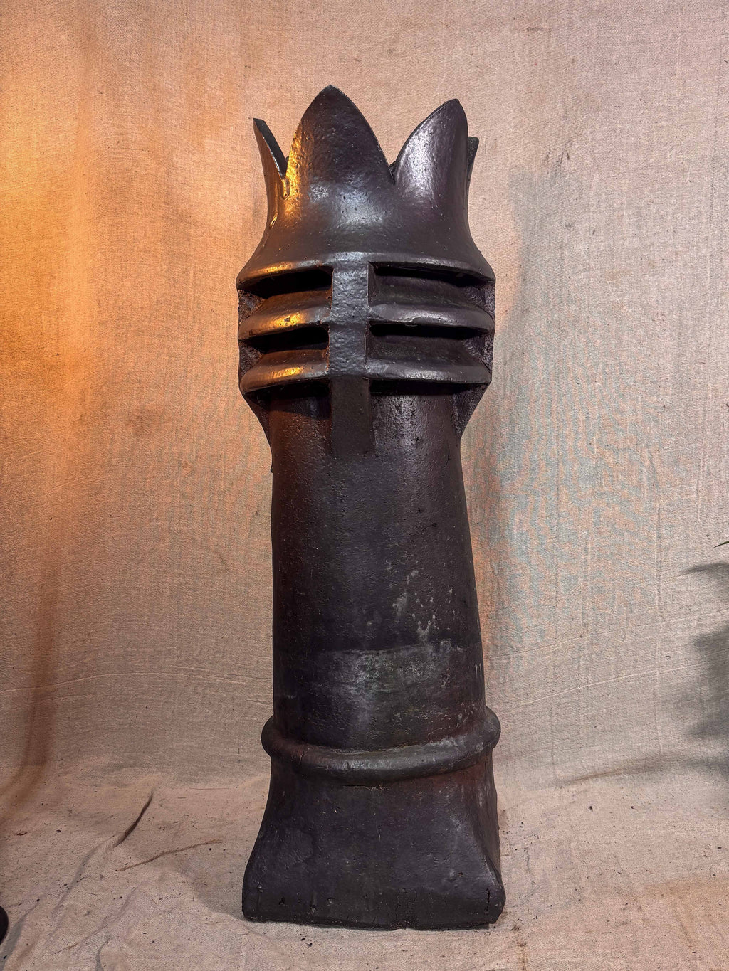 Decorative crown top chimney on a textured beige background