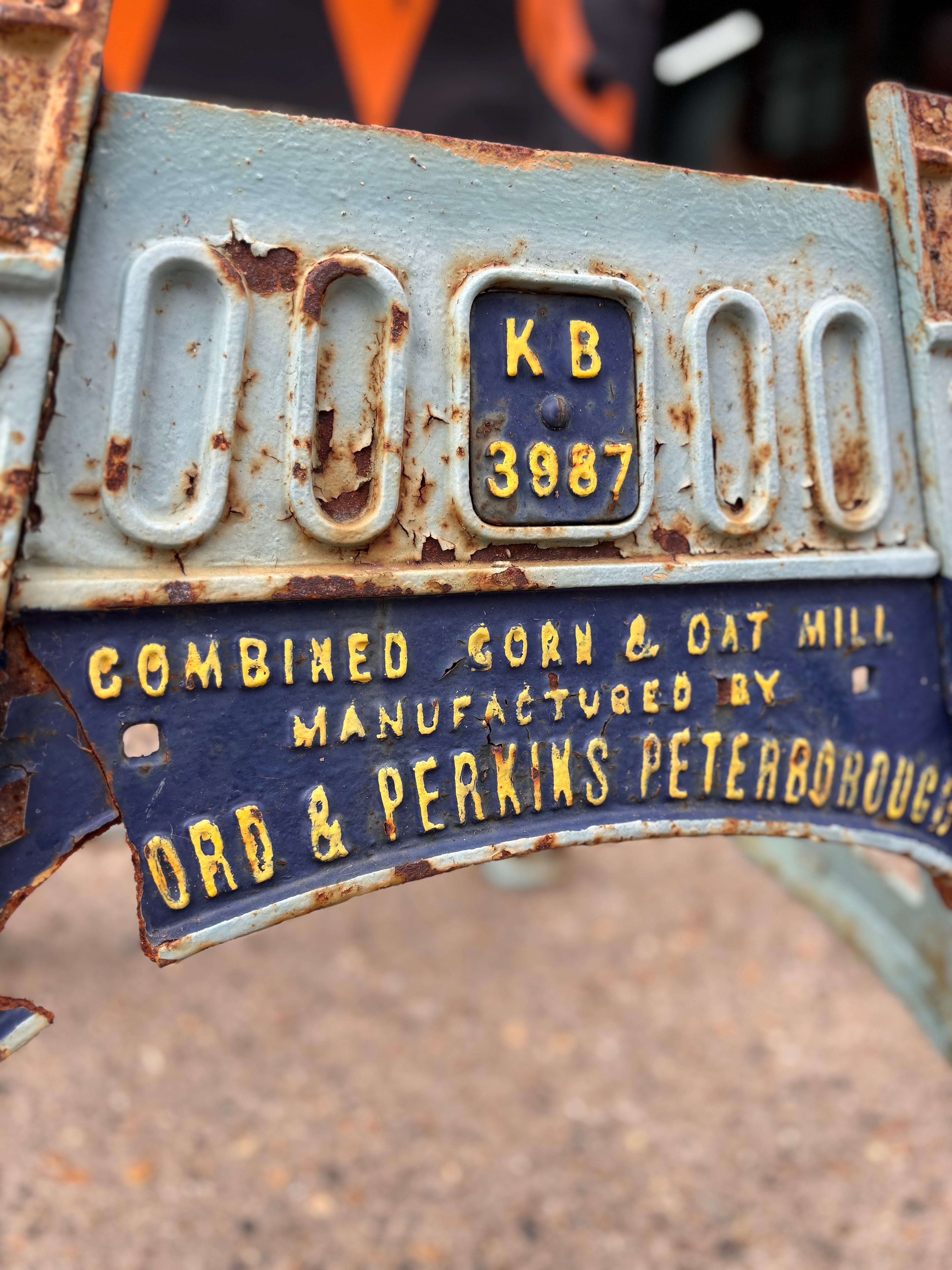 Rust-covered metal machine base with text and a on a blurred background